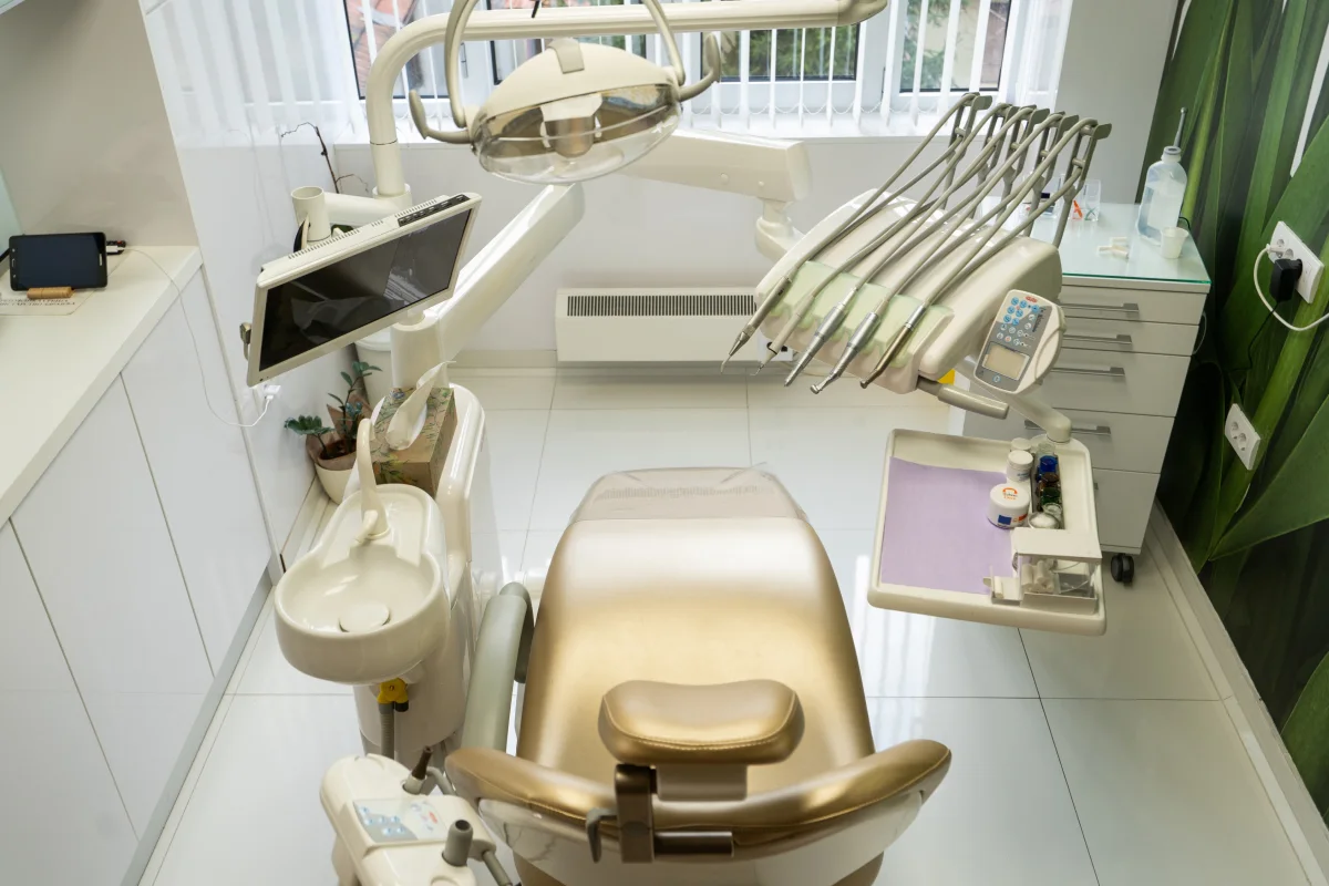 Dental chair with instruments on the arm and a screen for viewing X-rays